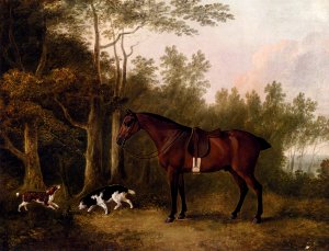 A Bay Hunter And Two Spaniels In A Landscape